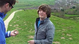Ash gives his wallet and other valuables to Tao before rolling down Glastonbury Tor